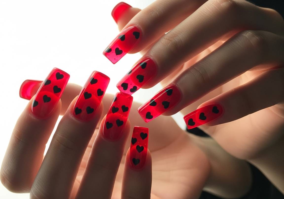 7. Jelly Red with Black Heart Details
Square Valentines Nails